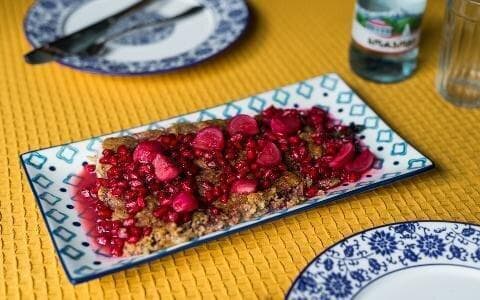 Baked trout with nuts in pomegranate sauce